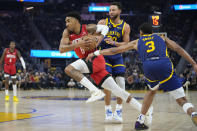 Houston Rockets forward Kenyon Martin Jr. (6) drives to the basket against Golden State Warriors guards Jordan Poole (3) and Stephen Curry (30) during the first half of an NBA basketball game in San Francisco, Saturday, Dec. 3, 2022. (AP Photo/Godofredo A. Vásquez)