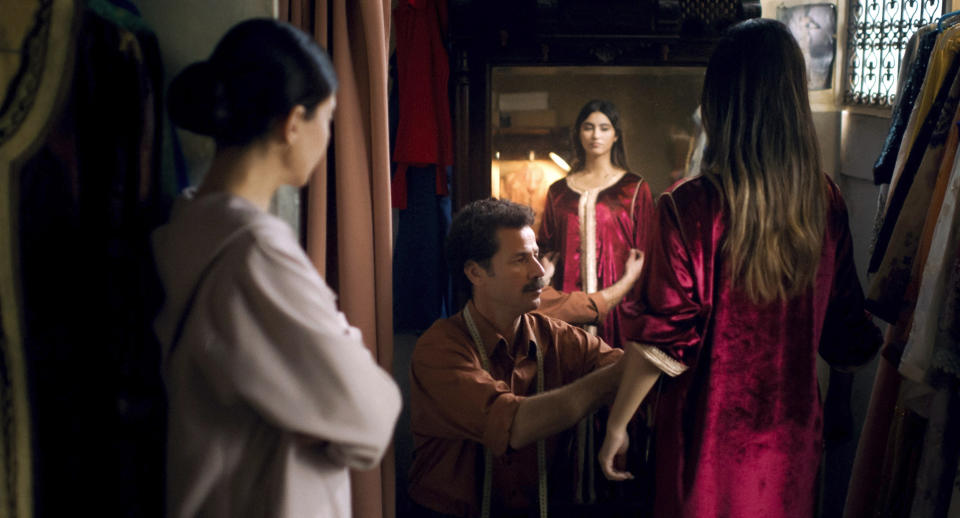 This photo provided by Ali n' Productions shows Saleh Bakri, center, as Halim in a scene from the movie "The Blue Caftan" directed by Maryam Touzani. “I’m really hoping that it would be able to trigger a debate about the LGBT community and its place …, things that we don’t generally talk about because they are sensitive subjects,” Touzani says. “For a healthy society, it’s important to be able to talk about everything.” (Ali n' Productions via AP)