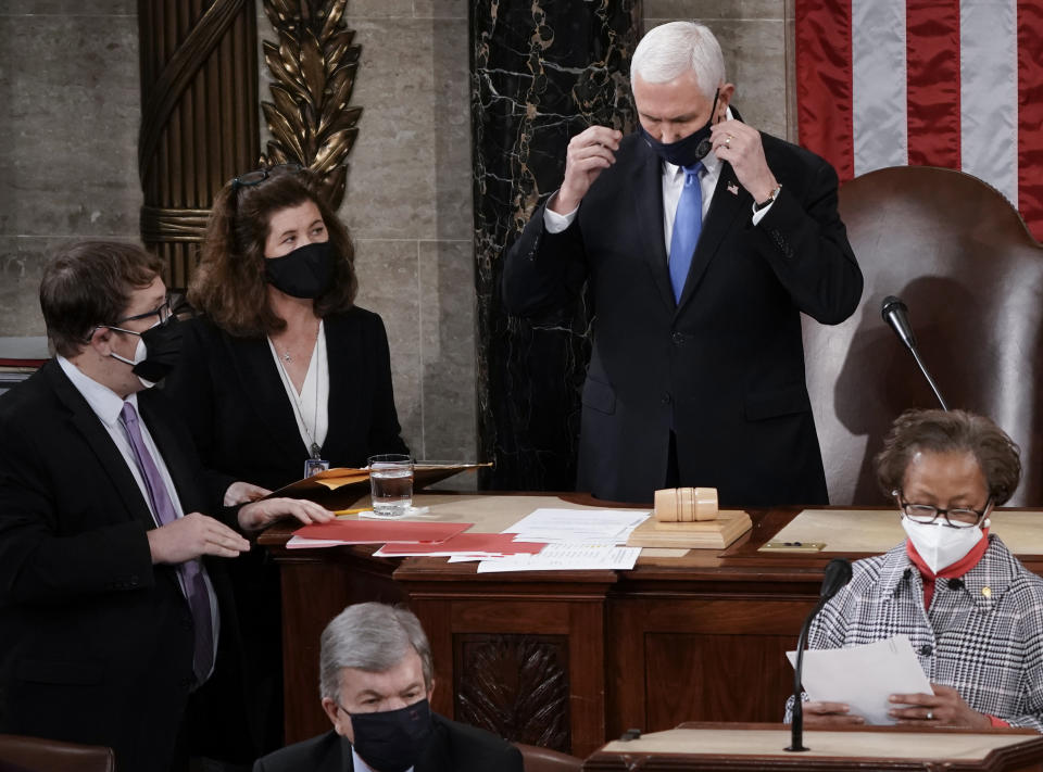 In this Jan. 6, 2021, photo, Senate Parliamentarian Elizabeth MacDonough, left, works beside Vice President Mike Pence during the certification of Electoral College ballots in the presidential election, in the House chamber at the Capitol in Washington. Shortly afterward, the Capitol was stormed by rioters determined to disrupt the certification. MacDonough has guided the Senate through two impeachment trials, vexed Democrats and Republicans alike with parliamentary opinions and helped rescue Electoral College certificates from a pro-Trump mob ransacking the Capitol. (AP Photo/J. Scott Applewhite)