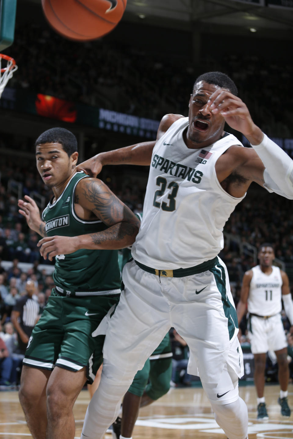 Michigan State's Xavier Tillman, right, and Binghamton's Sam Sessions vie for the ball during the first half of an NCAA college basketball game, Sunday, Nov. 10, 2019, in East Lansing, Mich. (AP Photo/Al Goldis)