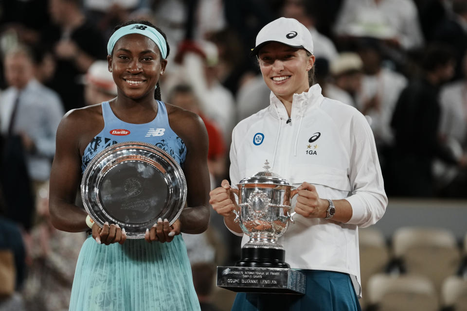 FILE - Poland's Iga Swiatek, right, holds the trophy after winning the final against Coco Gauff, left, in two sets, 6-1, 6-3, at the French Open tennis tournament in Roland Garros stadium in Paris, France, Saturday, June 4, 2022. When the Australian Open begins the 2023 Grand Slam season Monday morning (Sunday night EST), Gauff will be scheduled to start the action in Rod Laver Arena against Katerina Siniakova. Keep going all the way to the semifinals, and the No. 7-seeded Gauff might just end up facing No. 1 Iga Swiatek. (AP Photo/Thibault Camus, File)