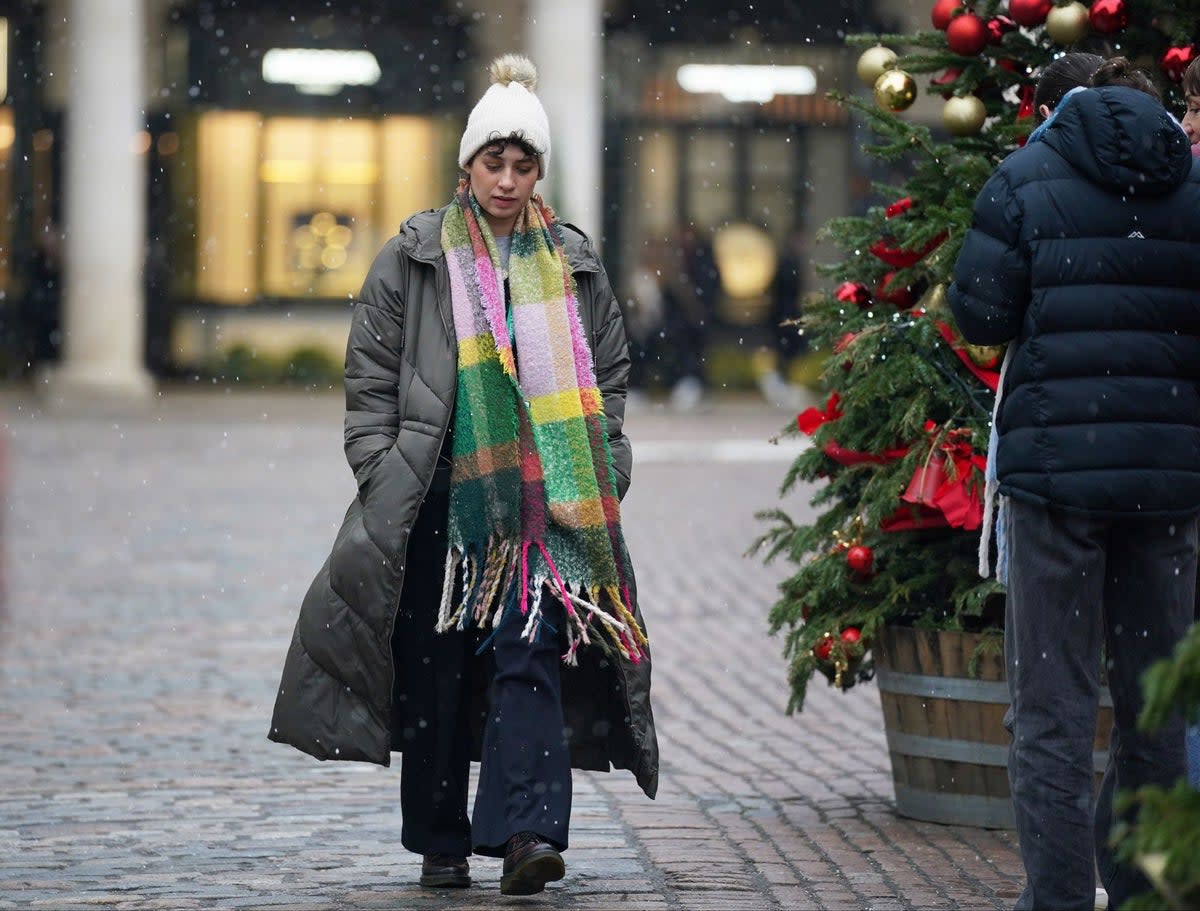 A person walks through snow in Covent Garden on Monday (PA)