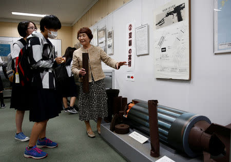 Haruyo Nihei explains to the school girls visiting a museum about the March 10, 1945 U.S. firebombing in Tokyo, Japan April 19, 2019. Picture taken April 19, 2019. REUTERS/Kim Kyung-hoon