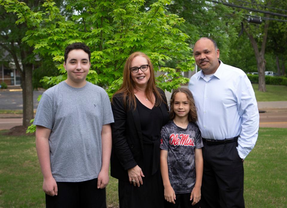 Anna Lopez with her husband Jose, left, and children Andrew, right, and Ethan in front of the tree planted in honor of her son Grant who died after a car crash. Lopez chose to donate Grant's organs after his death.