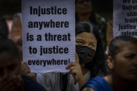 An activist holds a placard during a protest against remission of sentence by the government to convicts of a gang rape, in New Delhi, India, Thursday, Aug. 18, 2022. A Muslim woman who was gang raped while pregnant during India's devastating 2002 religious riots has appealed to the government to rescind its decision to free the 11 men who had been jailed for life for committing the crime, after they were released on suspended sentences. (AP Photo/Altaf Qadri)