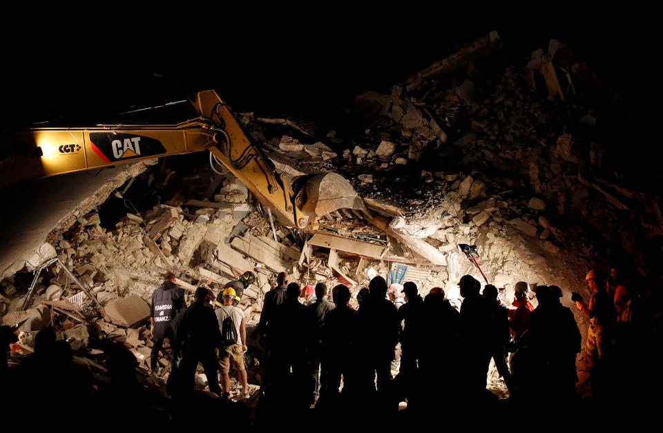 Rescuers work in the night ollowing an earthquake in Pescara del Tronto