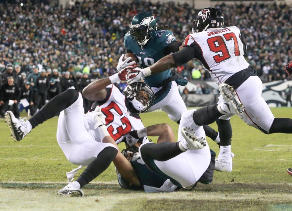 Eagles running back LeGarrette Blount (center) pushes into the end zone ahead of Atlanta's LaRoy Reynolds (53) and Grady Jarrett in the second quarter of a NFC Divisional Playoff at Lincoln Financial Field Saturday.