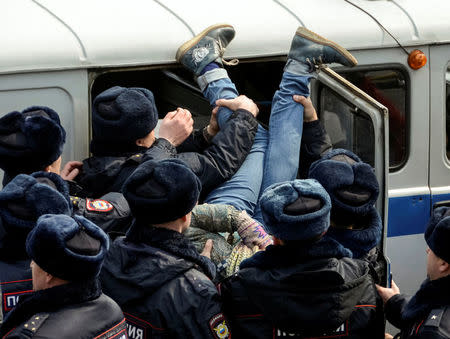 Police officers detain an opposition supporter during a rally in Vladivostok, Russia. REUTERS/Yuri Maltsev