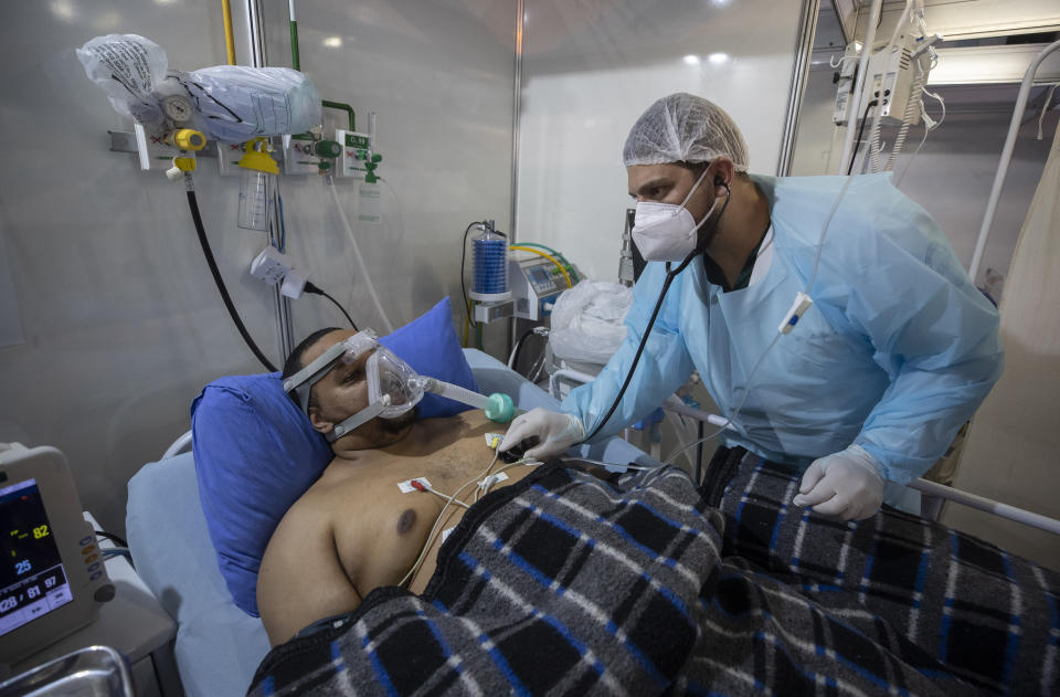 COVID-19 patient Everton Nascimento de Oliveira, 32, receives treatment at the emergency unit of a field hospital set up for COVID patients in Ribeirao Pires, greater Sao Paulo area, Brazil, Tuesday, April 13, 2021. (AP Photo/Andre Penner)