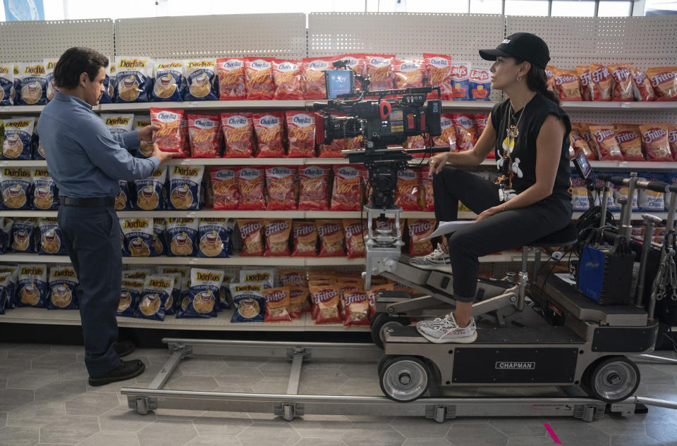 This image released by Searchlight Pictures shows Jesse Garcia, left, and director Eva Longoria on the set of "Flamin' Hot, a tale of how a Mexican American janitor came up with the idea for Flamin’ Hot Cheetos. (Emily Aragones/Searchlight Pictures via AP)