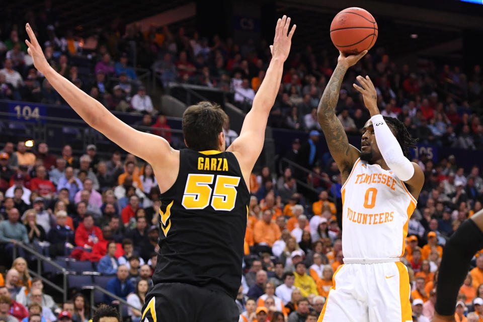 <p>Jordan Bone #0 of the Tennessee Volunteers shoots over Luka Garza #55 of the Iowa Hawkeyes in the second round of the 2019 NCAA Men’s Basketball Tournament held at Nationwide Arena on March 24, 2019 in Columbus, Ohio. (Photo by Jamie Schwaberow/NCAA Photos via Getty Images) </p>