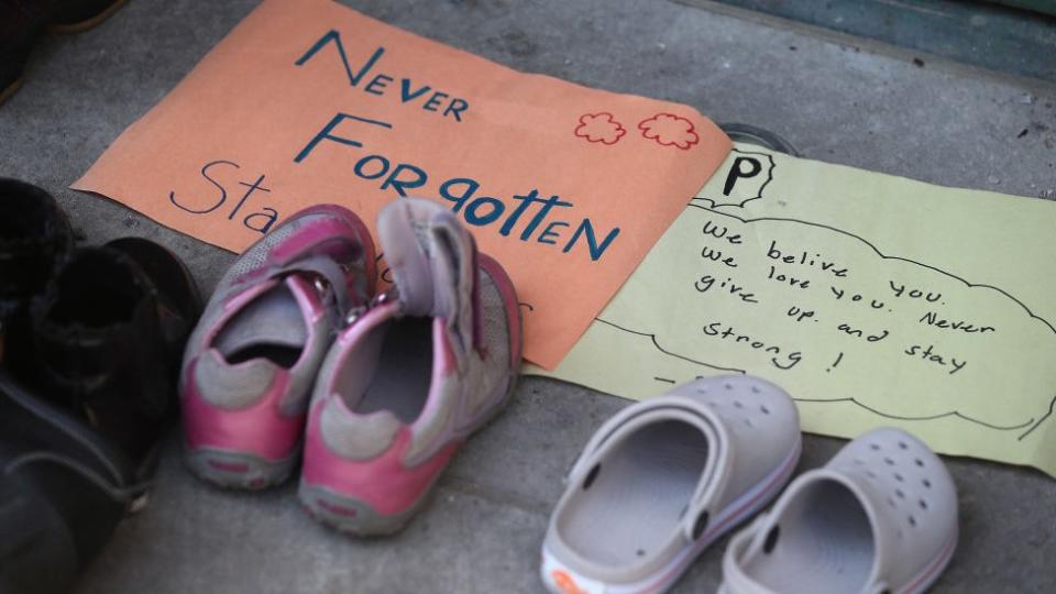 Shoes, flowers, candles and signs are on the steps of the Metropolitan United Church. Indigenous youth are holding a sit in front of the Ryerson statue near Church and Gould on the Ryerson University campus.