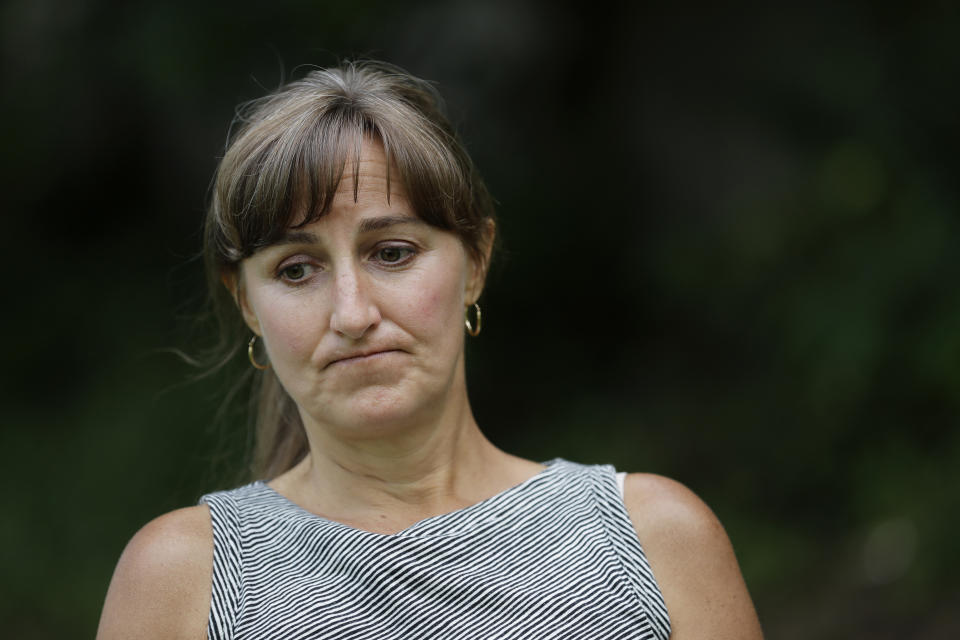 In this June 13, 2019, photo, Stacy Mullen-Deland, a former Spanish teacher at Sky Valley Education Center, pauses during an interview at her home in Snohomish, Wash. Mullen-Deland says she and her children have dealt with numerous ailments since they spent time at the school, including migraines, thyroid problems and learning and neurological issues. She and her husband are part of a lawsuit filed against the school district, the local health department and Monsanto, the maker polychlorinated biphenyls, or PCBs, which several families believe have made them sick. (AP Photo/Ted S. Warren)