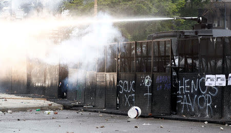 Police uses a water cannon during clashes outside the Congress, where the budget bill is being debated, in Buenos Aires, Argentina October 24, 2018. REUTERS/Martin Acosta