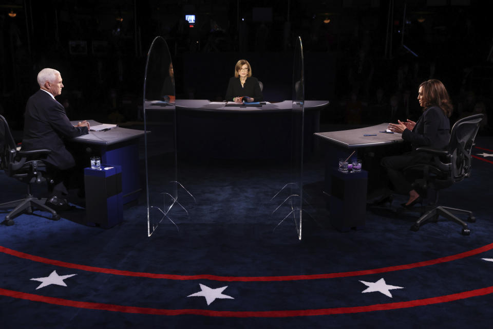 Vice President Mike Pence listens as Democratic vice presidential candidate Sen. Kamala Harris, D-Calif., speaks during the vice presidential debate Wednesday, Oct. 7, 2020, at Kingsbury Hall on the campus of the University of Utah in Salt Lake City. (Justin Sullivan/Pool via AP)