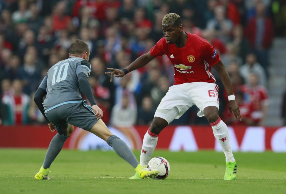 <p>Manchester United’s Paul Pogba in action with Celta Vigo’s Iago Aspas </p>