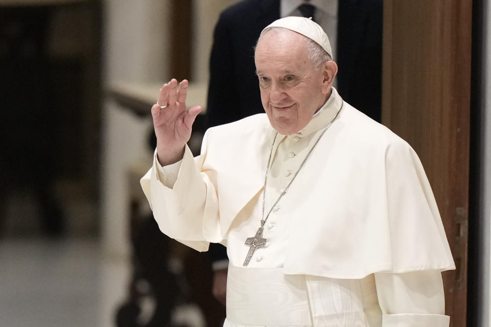 Pope Francis waves as he arrives for an audience with members of the members of the Antoniano children choir, at the Vatican, Saturday, March 19, 2022. (AP Photo/Andrew Medichini)