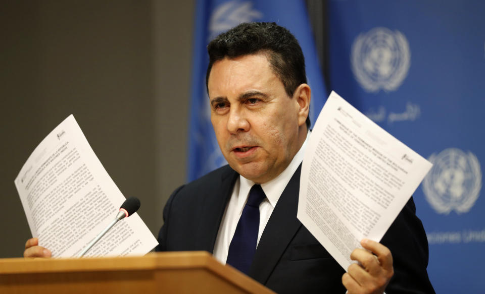 Samuel Moncada, Venezuela's ambassador to the United Nations, holds up documents from his office as he speaks during a news conference at the U.N. headquarters, Tuesday, April 30, 2019. (AP Photo/Kathy Willens)