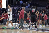 Vanderbilt's Scotty Pippen Jr., left, walks off the court as Temple's Tai Strickland (13) and teammates celebrate their 72-68 win in overtime in an NCAA college basketball game Tuesday, Dec. 7, 2021, in Nashville, Tenn. (AP Photo/Mark Humphrey)