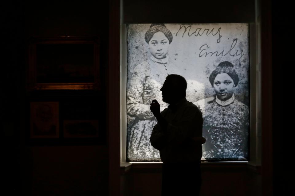 Michael Dyer, co-curator of the Sailing to Freedom: Maritime Dimensions of the Underground Railroad, walks past a backlit daguerreotype showing two teenage sisters, Mary, and Emily Edmonson, who were two of the seventy-seven people captured while seeking freedom aboard the schooner Pearl in 1848 bound for the Delaware Canal. After traumatic moves between the slave markets of Maryland and New Orleans, the sisters were emancipated through the efforts of Northern abolitionists.