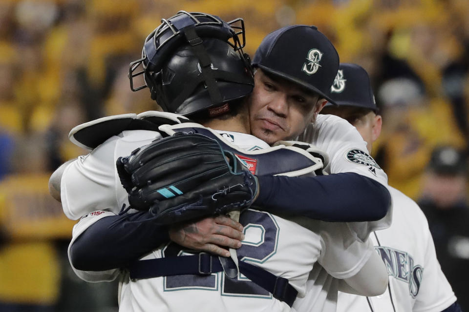 Seattle Mariners starting pitcher Felix Hernandez, right, hugs catcher Omar Narvaez as Hernandez leaves the team's baseball game against the Oakland Athletics during the sixth inning Thursday, Sept. 26, 2019, in Seattle, in Hernandez's final start of the season. (AP Photo/Ted S. Warren)