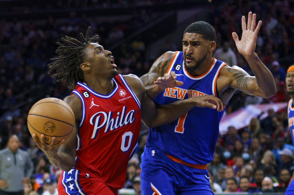 Philadelphia 76ers' Tyrese Maxey, left, drives to the basket against New York Knicks' Obi Toppin during the second half of an NBA basketball game Friday, Nov. 4, 2022, in Philadelphia. (AP Photo/Chris Szagola)