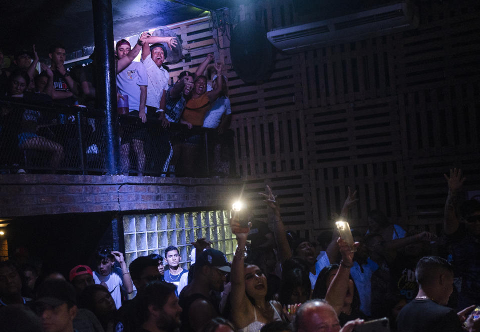 People cheer for their contestant during the final of the first Miss Colonia pageant hosted by the Factoría nightclub in Veracruz, Mexico, Sunday, March 5, 2023. The nightclub held the pageant as part of annual Women’s Day events and the only requirement for contestants was to prove residency in working-class areas of the city, known as "colonias." Prizes originally covered utility bills and property taxes, but when the event attracted more sponsors the prizes expanded to include cash, travel, dental work, spas and makeovers. (AP Photo/Felix Marquez)