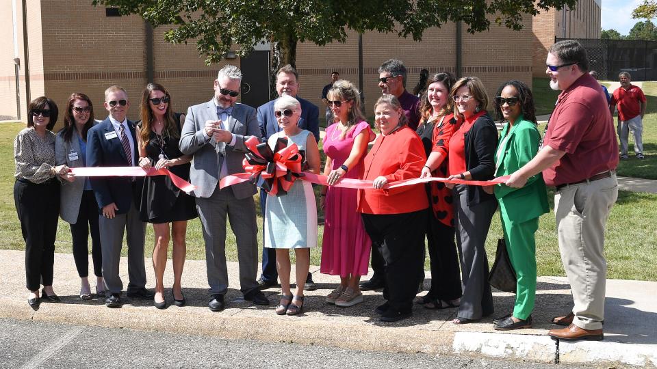 Joey Battles, dean of Health Sciences, and Kathy Murphy, school president, are in the forefront of the ceremonial ribbon-cutting Oct. 2 for renovations to Gadsden State's Bevill and Helderman Halls, which house its Health Sciences programs.