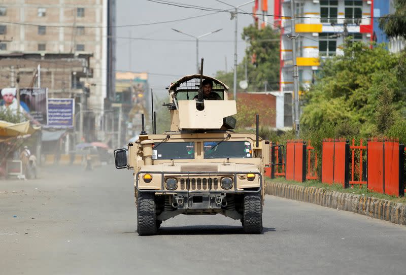 Army vehicle patrols near the site of an attack on a jail compound in Jalalabad