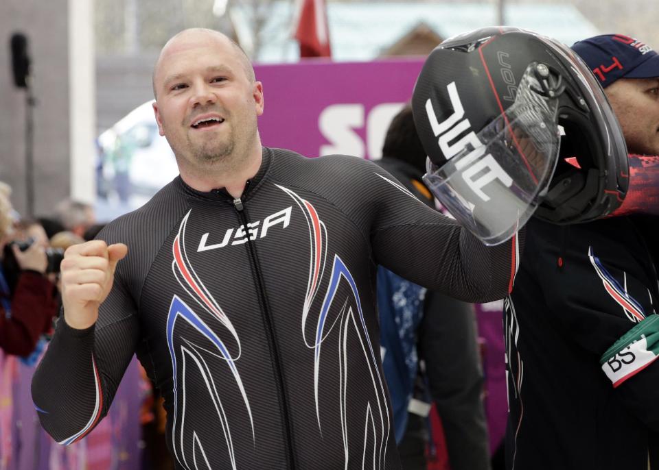 The driver of United States USA-1, Steven Holcomb, acknowledges the crowd after the team won the bronze medal during the men's four-man bobsled competition final at the 2014 Winter Olympics, Sunday, Feb. 23, 2014, in Krasnaya Polyana, Russia. (AP Photo/Jae C. Hong)