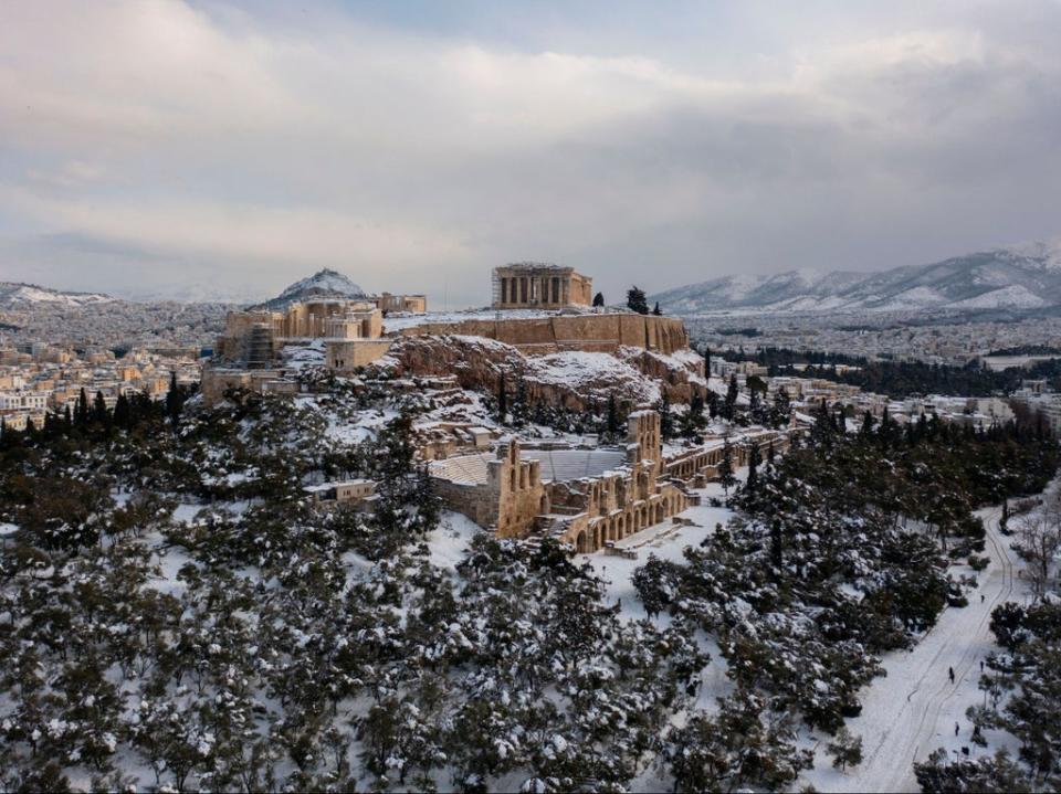 The snow covered Ancient Temple of Parthenon atop the Acropolis hill (AFP via Getty Images)