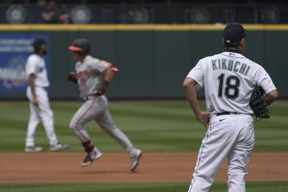 Seattle Mariners starting pitcher Yusei Kikuchi (18) watches as Baltimore Orioles' Pat Valaika rounds the bases after he hit a solo home run in the seventh inning of a baseball game, Wednesday, May 5, 2021, in Seattle. (AP Photo/Ted S. Warren)