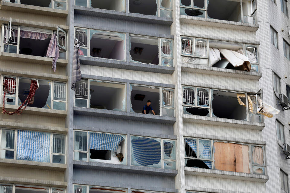 <p>A man looks out from inside an apartment where some windows have been broken by typhoon Hato in Macau, China, Aug. 24, 2017. (Photo: Tyrone Siu/Reuters) </p>