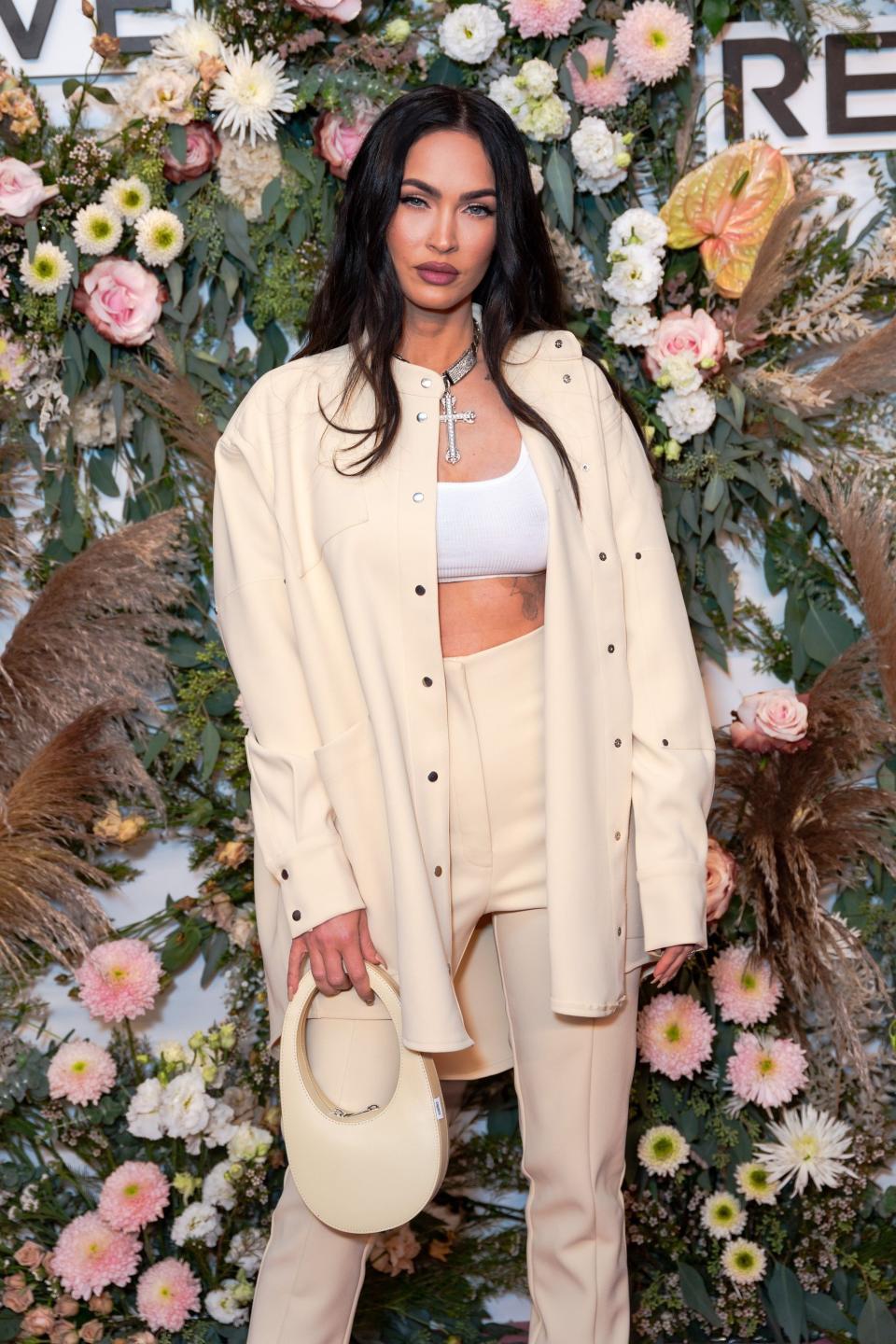 Megan posing in front of a floral background