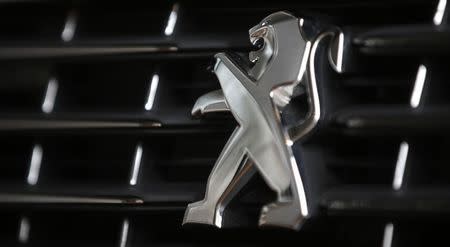 A Peugeot logo is seen on a car which is displayed at PSA Peugeot Citroen headquarters during the company's 2014 annual results presentation in Paris, February 18, 2015. REUTERS/Christian Hartmann