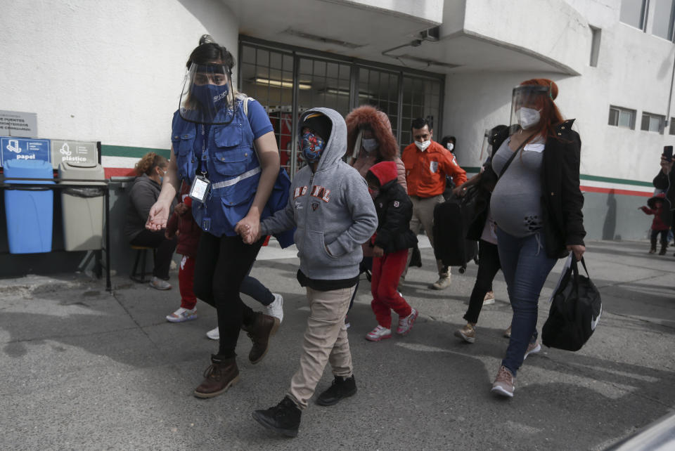 A migrant family crosses the border into El Paso, Texas, in Ciudad Juarez, Mexico, Friday, Feb. 26, 2021. After waiting months and sometimes years in Mexico, people seeking asylum in the United States are being allowed into the country as they wait for courts to decide on their cases, unwinding one of the Trump administration's signature immigration policies that President Joe Biden vowed to end. (AP Photo/Christian Chavez)