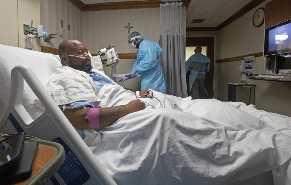 Cedric Daniels, 37, of Gonzales, La., rests in his room, recovering from COVID-19 at Our Lady of the Lake Regional Medical Center in Baton Rouge, Monday, Aug. 2, 2021. Louisiana is leading the nation in the number of new COVID cases per capita and remains one of the bottom five states in administering vaccinations. (AP Photo/Ted Jackson)
