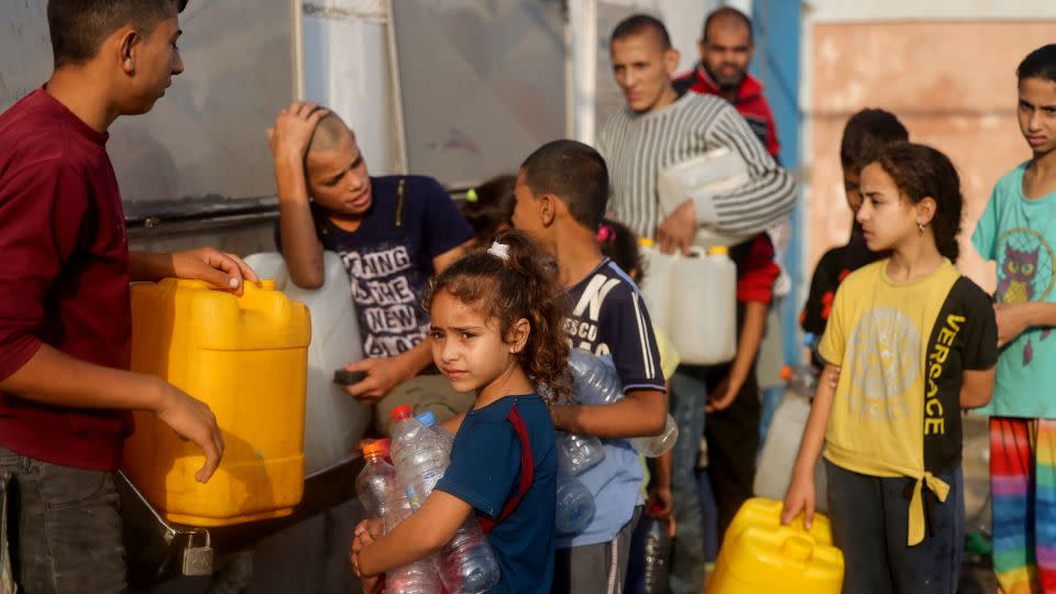 Palestinians wait in line to refill their water containers in Rafah on the south of Gaza, October 24, 2023. - Mohammed Abed/AFP/Getty Images