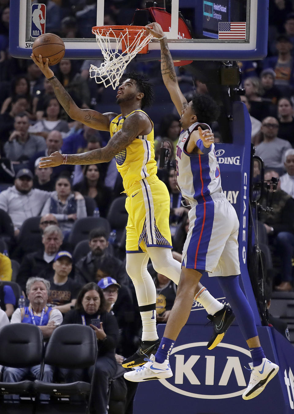 Golden State Warriors' Marquese Chriss, left, lays up a shot against Detroit Pistons' Christian Wood during the first half of an NBA basketball game Saturday, Jan. 4, 2020, in San Francisco. (AP Photo/Ben Margot)