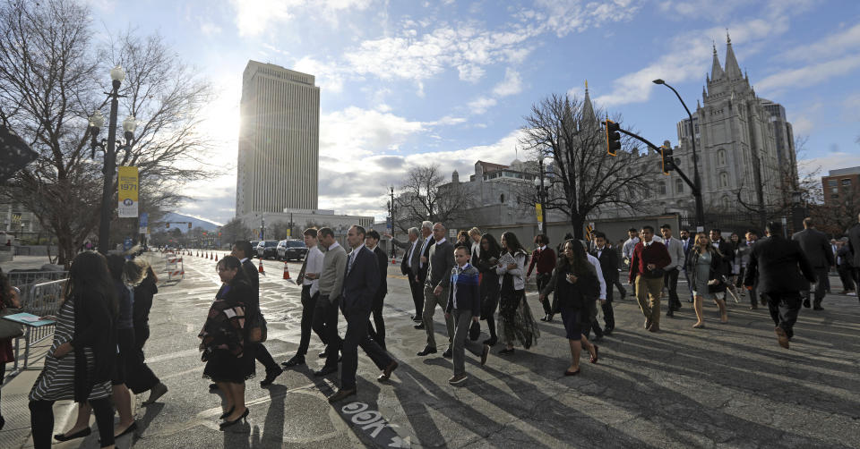 People arrive for The Church of Jesus Christ of Latter-day Saints' two-day conference Saturday, April 6, 2019, in Salt Lake City. Church members are preparing for more changes as they gather in Utah for a twice-yearly conference to hear from the faith's top leaders. (AP Photo/Rick Bowmer)