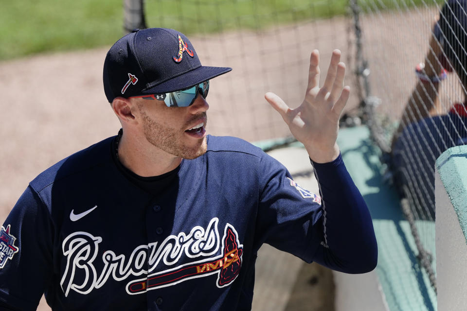 FILE - Atlanta Braves first baseman Freddie Freeman (5) waves to fans as he exits a spring training baseball game against the Boston Red Sox in Fort Myers, Fla., in this Tuesday, March 30, 2021, file photo. Georgia’s new voting law _ which critics claim severely limits access to the ballot box, especially for people of color _ has prompted calls from as high as the White House to consider moving the midsummer classic out of Atlanta. One of baseball’s biggest stars, Braves first baseman and reigning National League MVP Freddie Freeman, weighed in on the divisive issue Thursday, April 1, 2021, just a few hours before Atlanta opened the season in Philadelphia. Freeman said the game should remain at Truist Park, but be used as a platform to promote voting rights. (AP Photo/John Bazemore, File)