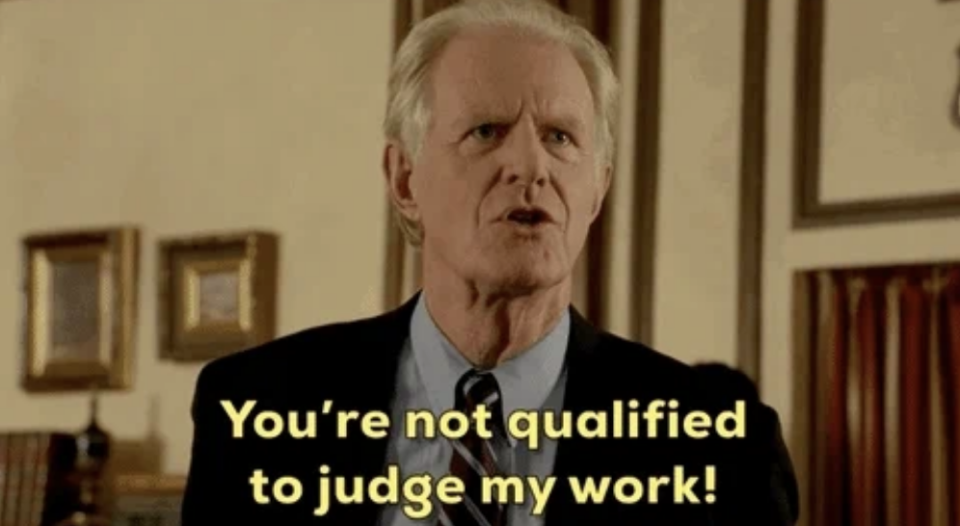 Professor Linkletter from Young Sheldon in a suit and tie, speaking fervently with the text: "You're not qualified to judge my work!"