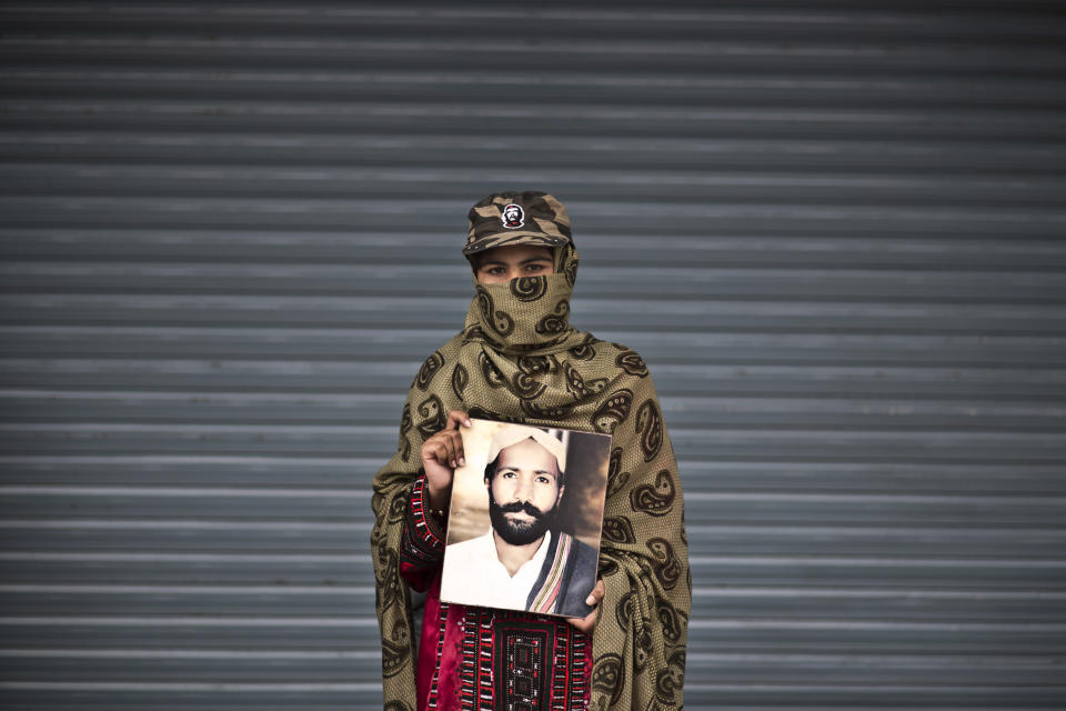 Sameena Haider, 14, poses for a portrait holding a photograph of her brother, who went missing on August 17, 2013, while she and other relatives take a break from a long march protest, in Rawalpindi, Pakistan, Friday, Feb. 28, 2014. She is part of a group of activists from the impoverished southwestern province of Baluchistan who walked roughly 3,000 kilometers (1,860 miles) to the capital of Islamabad to draw attention to alleged abductions of their loved ones by the Pakistani government. (AP Photo/Muhammed Muheisen)