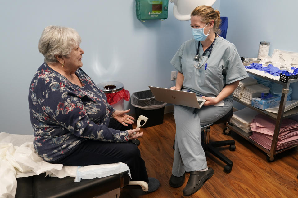 Dr. Catherine Casto, right, talks with Catherine Burns, left, of Millsboro, Del., during a visit to a Chesapeake Health Care office in Salisbury, Md., Thursday, March 2, 2023. Burns has been seeing Dr. Casto for 25 years. (AP Photo/Susan Walsh)