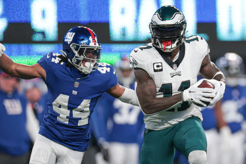 Jan 7, 2024; East Rutherford, New Jersey, USA; Philadelphia Eagles wide receiver A.J. Brown (11) catches the ball as New York Giants cornerback Nick McCloud (44) pursues during the first quarter at MetLife Stadium. Mandatory Credit: Vincent Carchietta-USA TODAY Sports