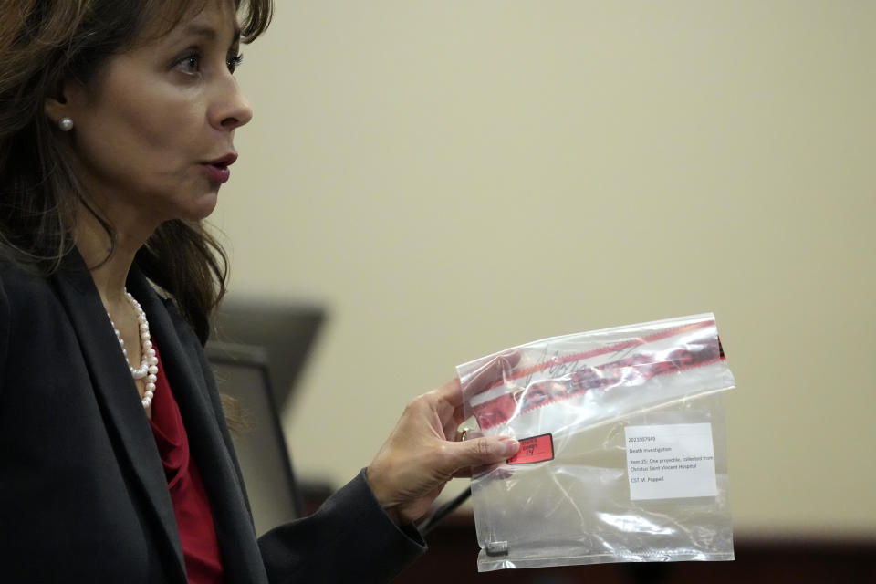 Special prosecutor Erlinda Ocampo Johnson shows a bullet in an evidence bag during actor Alec Baldwin's involuntary manslaughter hearing, in District Court, in Santa Fe, N.M., Wednesday, July 10, 2024. (AP Photo/Ross D. Franklin, Pool)