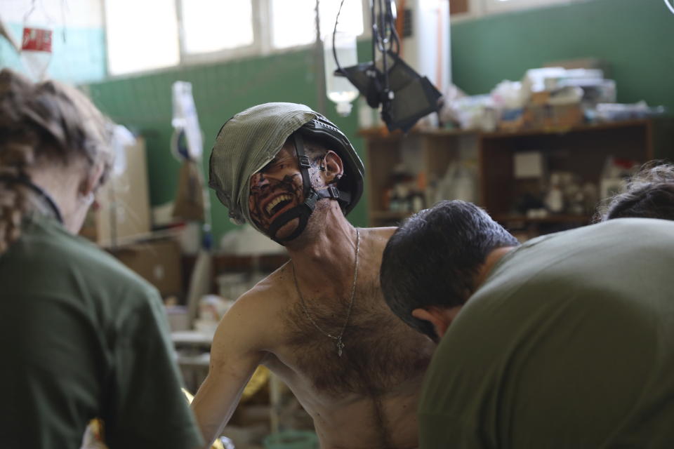 Medics help an injured Ukrainian serviceman in a frontline medical stabilization point in Zaporizhzhia region, Ukraine, Thursday, July 27, 2023. (AP Photo/Kateryna Klochko)