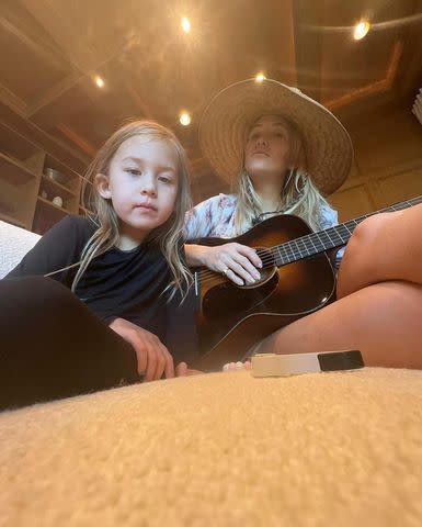 <p>Kate Hudson /Instagram </p> Kate Hudson playing the guitar with her daughter, as seen on the star's Instagram.