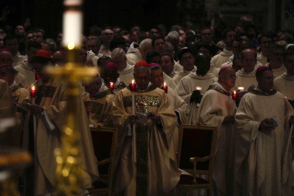 Cardinals hold candles as Pope Francis presides over an Easter vigil ceremony in St. Peter's Basilica at the Vatican, Saturday, April 8, 2023. (AP Photo/Gregorio Borgia)