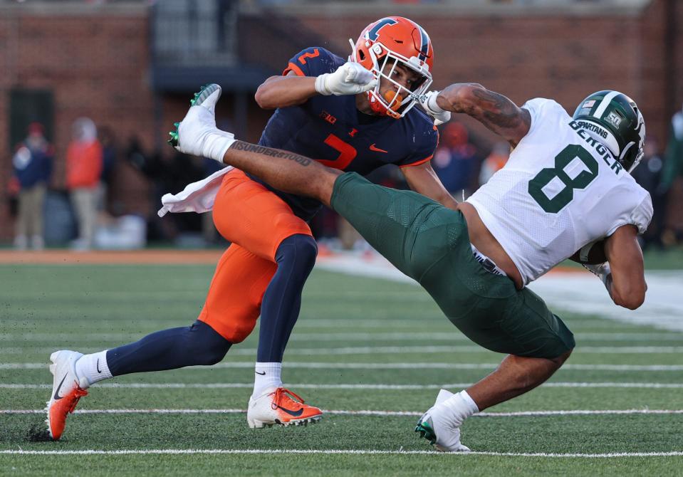 Matthew Bailey (2) of the Illinois Fighting Illini makes the hit on Jalen Berger (8) of the Michigan State Spartans during the second half at Memorial Stadium on November 5, 2022 in Champaign, Illinois.